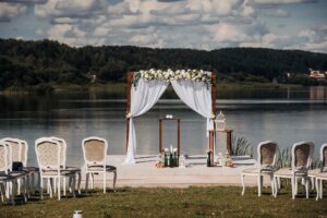 Wedding ceremony on the street on the green lawn.Decor with fresh flowers arches for the ceremony