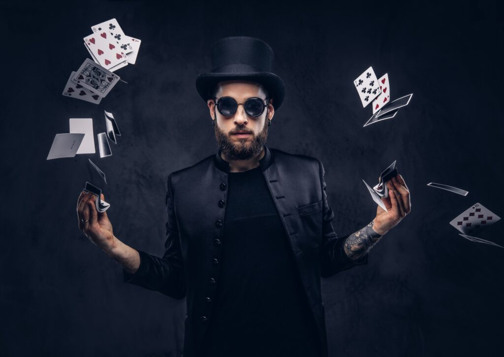 Magician showing trick with playing cards.